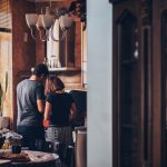 Surviving a kitchen renovation shown with a couple working together in a kitchen, highlighting teamwork and patience during the renovation process